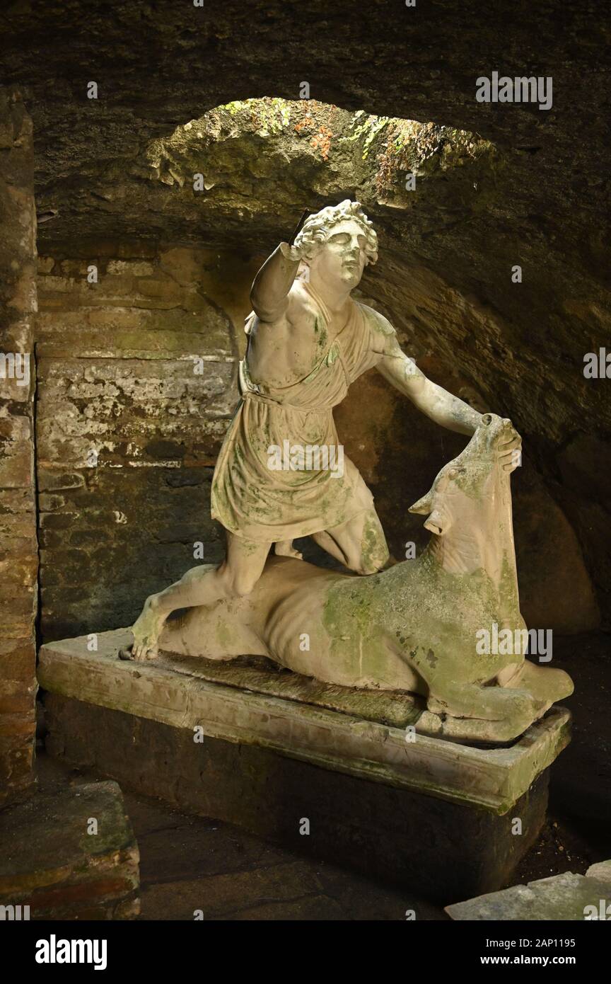 Rome. Italy. Ostia Antica. Mithraeum of the Baths of Mithras (Mitreo delle Terme del Mitra). Mithras about to kill the bull, cast of the original 1st Stock Photo