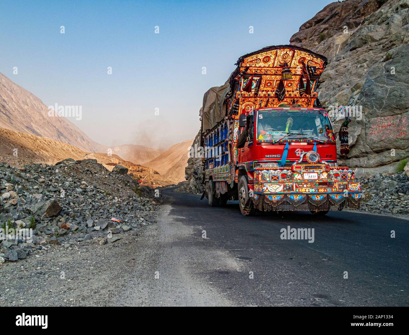 Colorfully decorated and painted trucks are driving on the dusty roads of Karakorum Highway Stock Photo