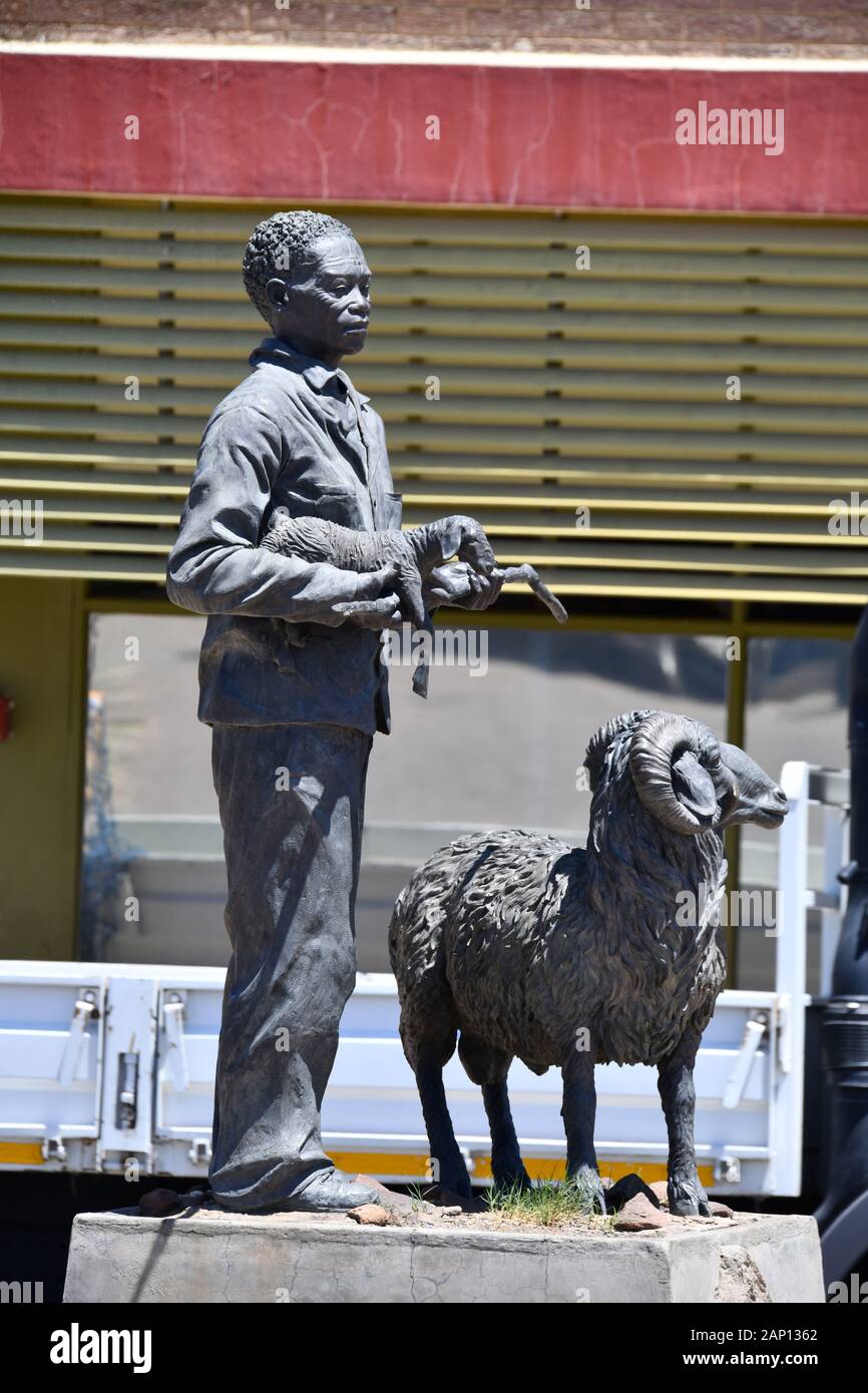 Bronze Karakul statue in Keetmanshoop, taken on 22.02.2019, it shows a Nama shepherd with a newborn lamb in his arms and a ram. This statue is said to symbolize the Namibian Karakul sheep industry. The sculpture created by the Namibian artist Christina Salvoldi was unveiled on September 13, 2007, the 100th anniversary of the development of the Karakul fur industry in Namibia. Photo: Matthias Toedt/dpa-Zentralbild/ZB/Picture Alliance | usage worldwide Stock Photo