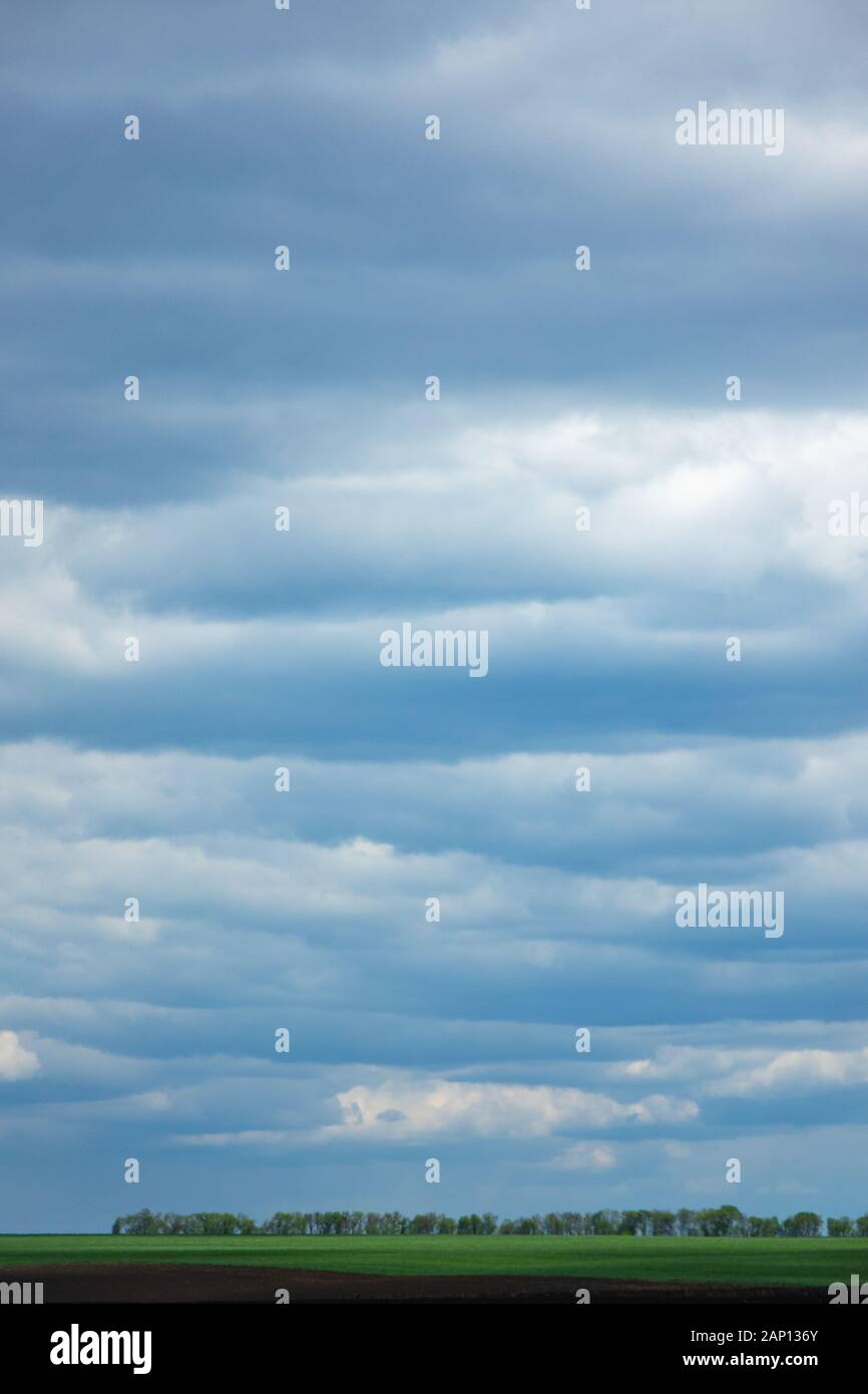 Farmland landscape on a background of cloudy sky Stock Photo - Alamy
