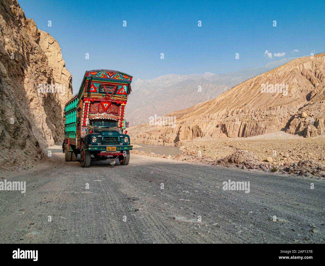 Colorfully decorated and painted trucks are driving on the dusty roads of Karakorum Highway Stock Photo