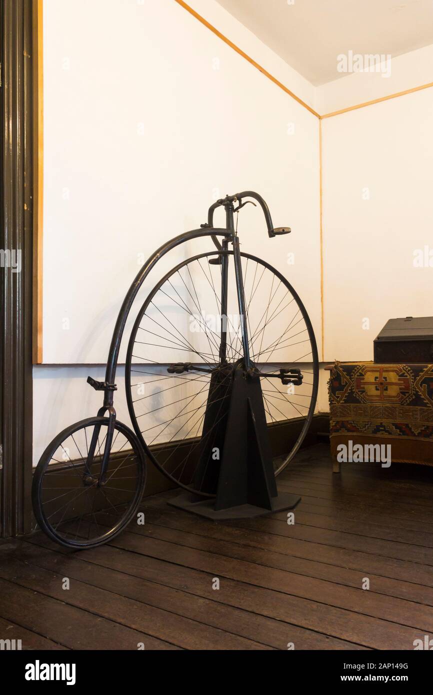 Penny Farthing bicycle on display at Turton Tower, Lancashire. The stone-built central section of the building dates from the 14th century. Stock Photo