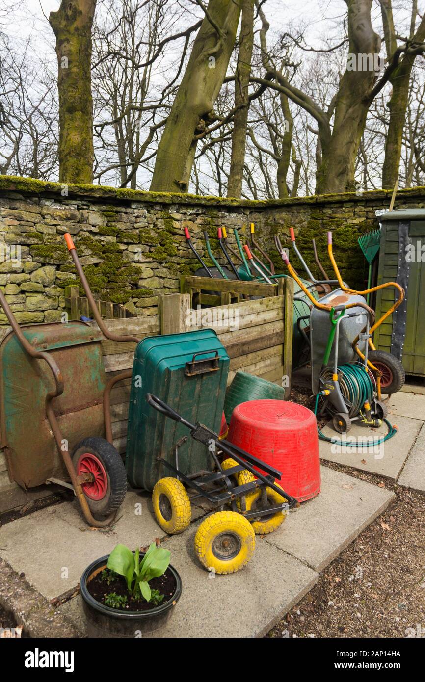Wheelbarows and gardening equipment stored at the volunteer-maintained kitchen garden of Turton Tower, Lancashire. Stock Photo