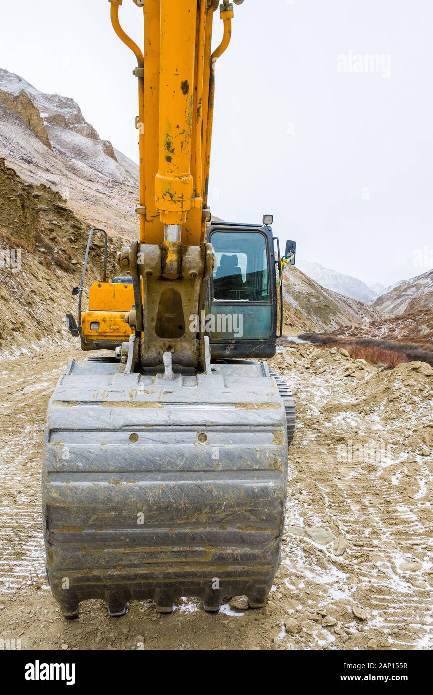 An excavator / JCB building a new road through the Nepalese Himalayan region of Dolpo Stock Photo