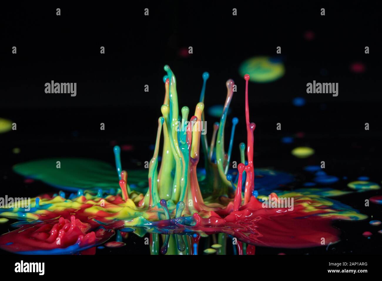 Color ink splash on a black background Stock Photo - Alamy