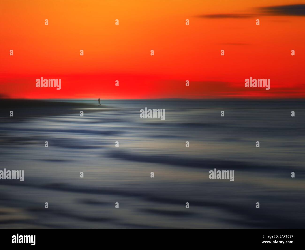 Silhouette of jogger on blurred beach at sunset Stock Photo