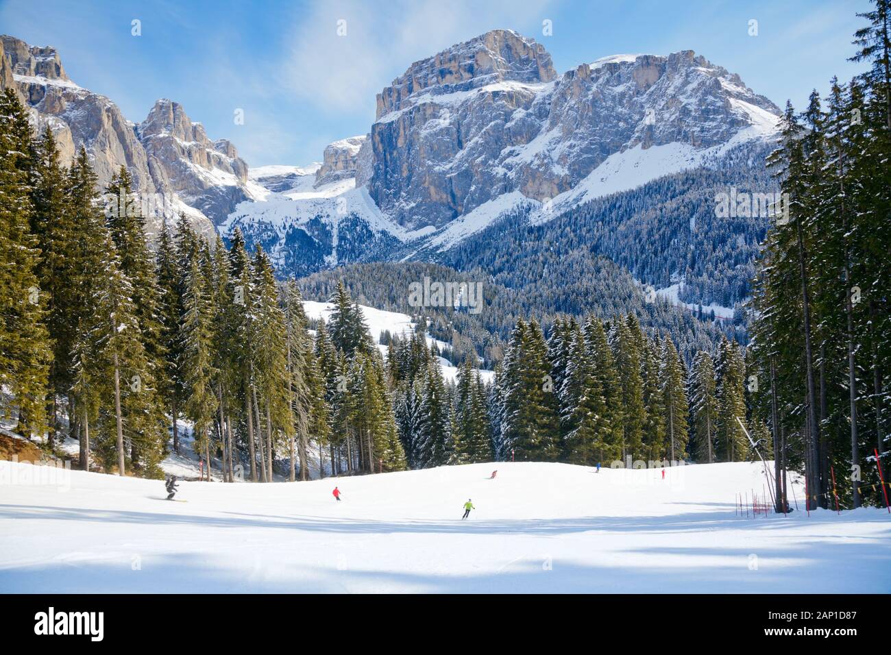 Skiers going down the slope at Sella Ronda ski route in Italy Stock Photo