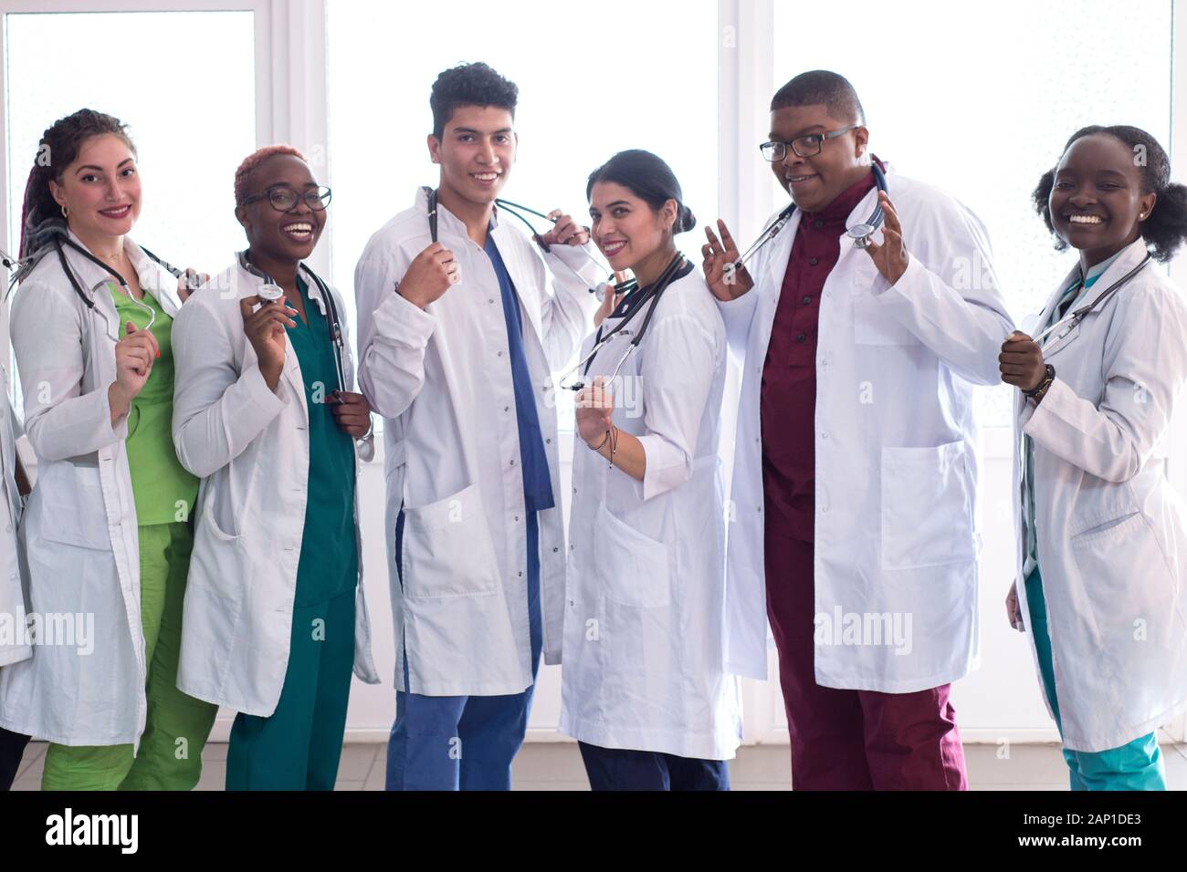 medical students, doctors, mixed race. A team of young people in white coats  posing in the hallway of the hospital Stock Photo - Alamy