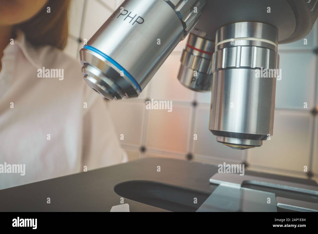 student girl looking in a microscope, science laboratory concept Stock ...