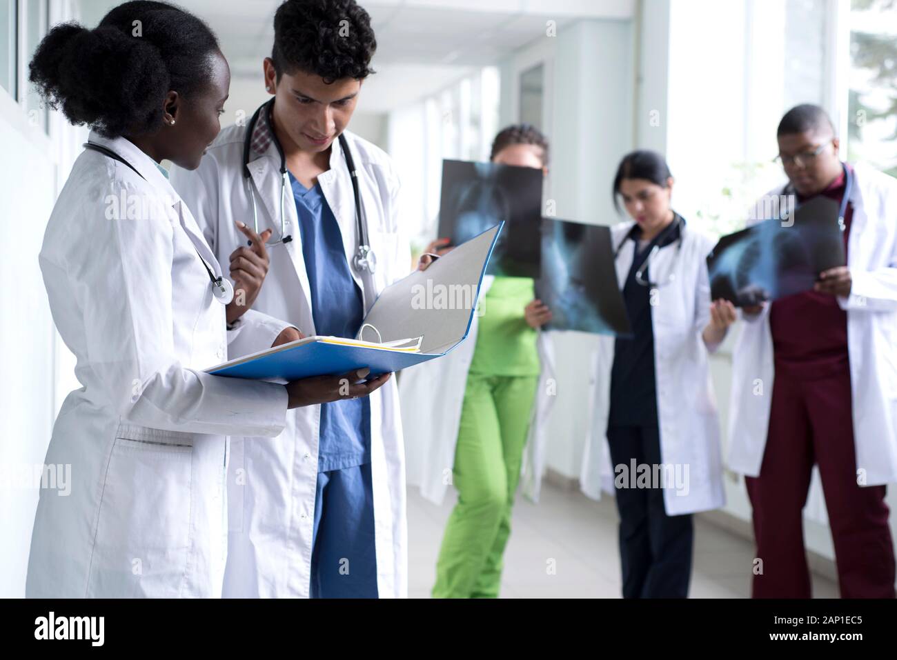 portrait of doctors, mixed race. A black girl, with a Mexican guy, in