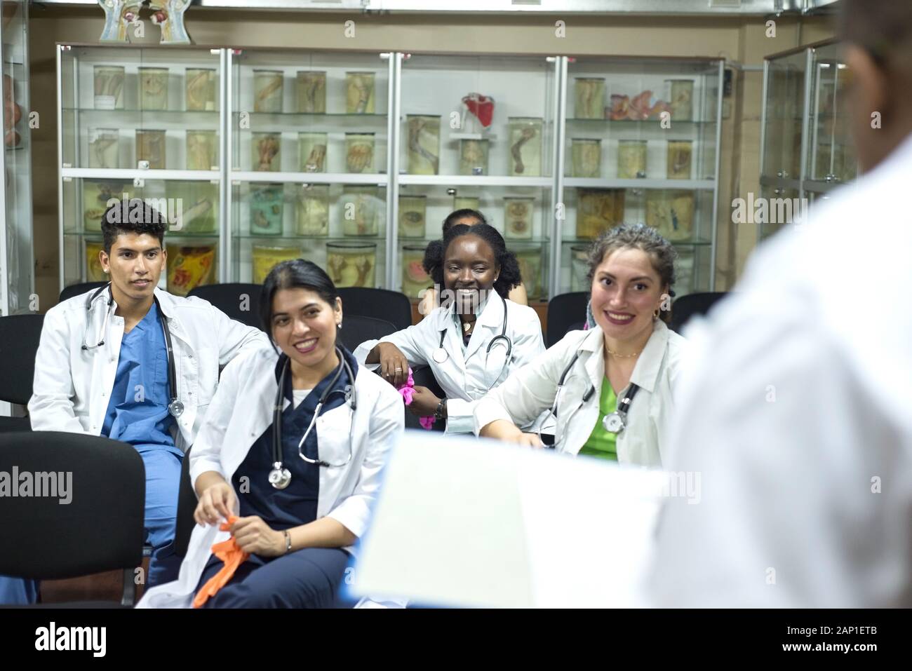 doctors, mixed race, in the classroom, at a medical conference. Young