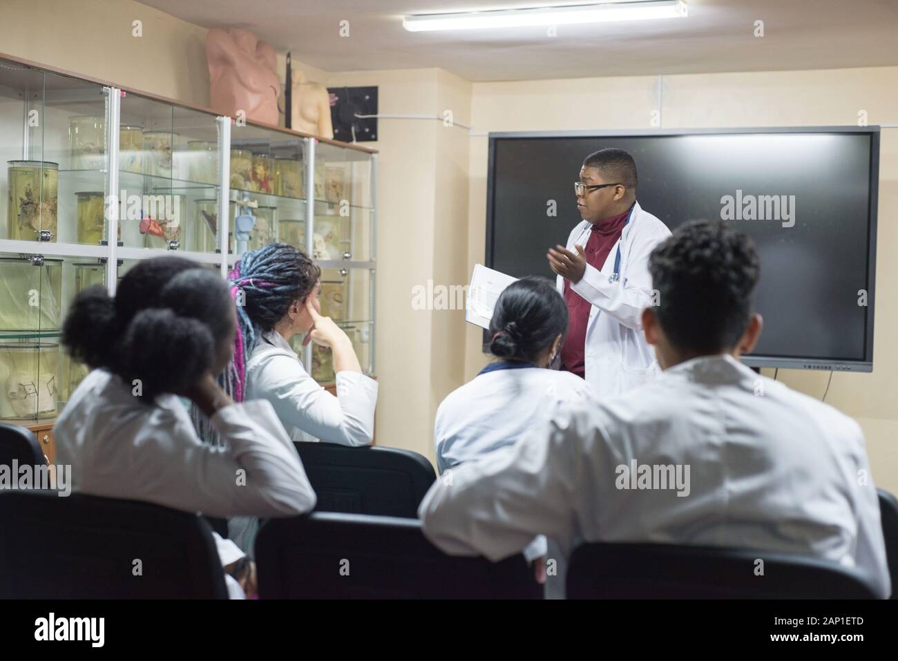 doctors, mixed race, in the classroom, at a medical conference. Young