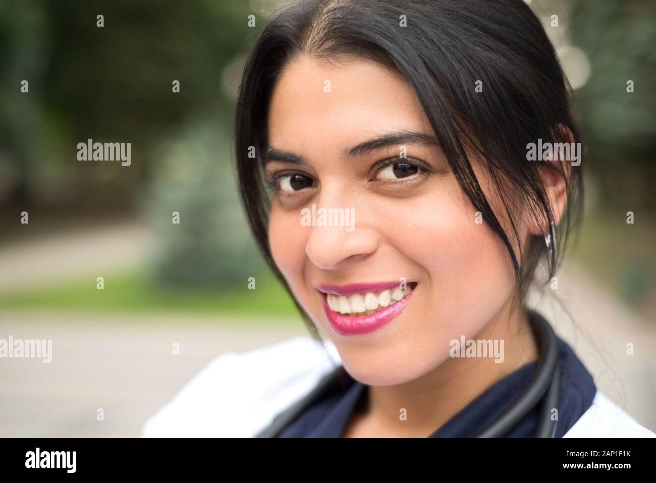 https://c8.alamy.com/comp/2AP1F1K/portrait-of-a-beautiful-young-mexican-girl-doctor-smiles-woman-in-a-white-coat-with-a-stethoscope-outdoor-in-2AP1F1K.jpg