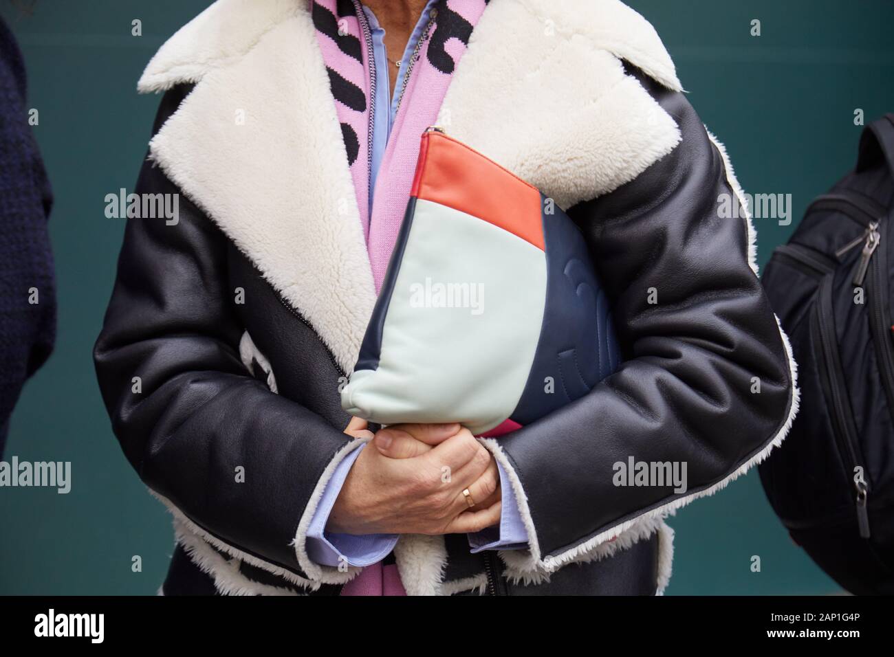 MILAN, ITALY - JANUARY 14, 2019: Woman with blue, orange and white Chanel leather bag and sheepskin jacket before Marco de Vincenzo fashion show, Mila Stock Photo