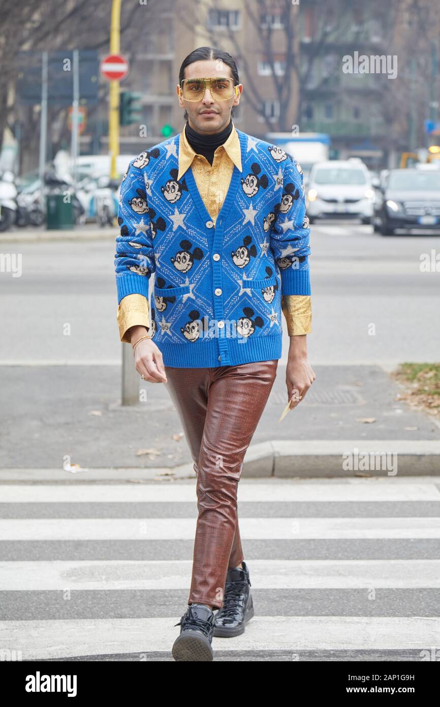 MILAN, ITALY - JANUARY 14, 2019: Man with yellow shirt and blue sweater  with Mickey Mouse before Gucci fashion show, Milan Fashion Week street  style Stock Photo - Alamy