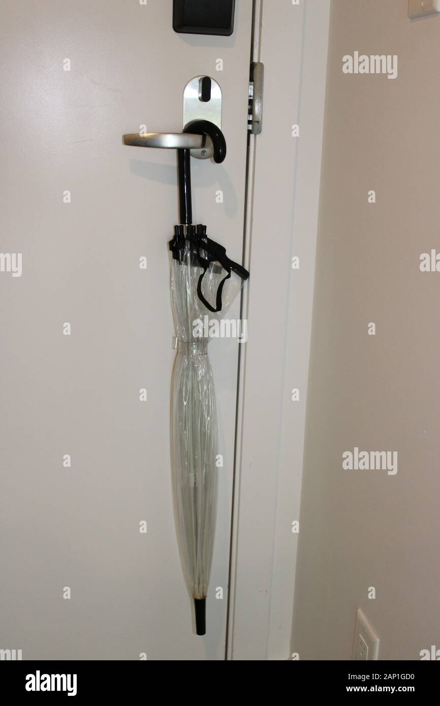 Clear umbrella hanging on wall Stock Photo Alamy