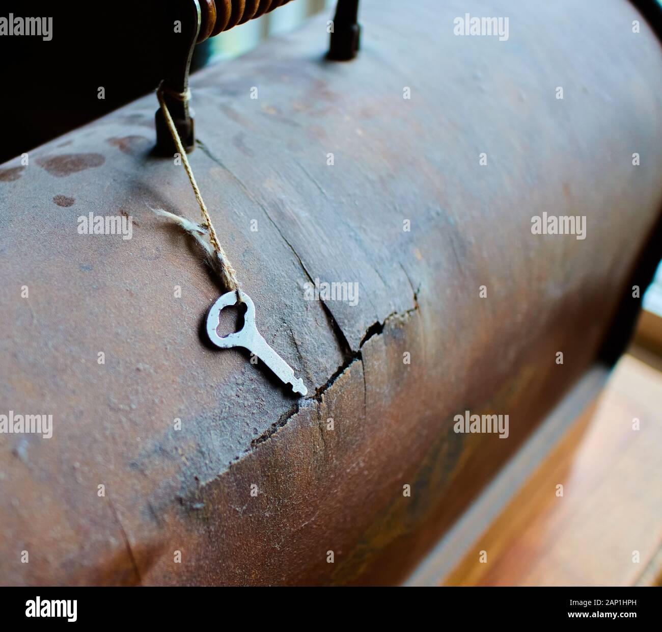 closeup of dusty, broken bentwood sewing machine case and key.  circa 1920s Stock Photo
