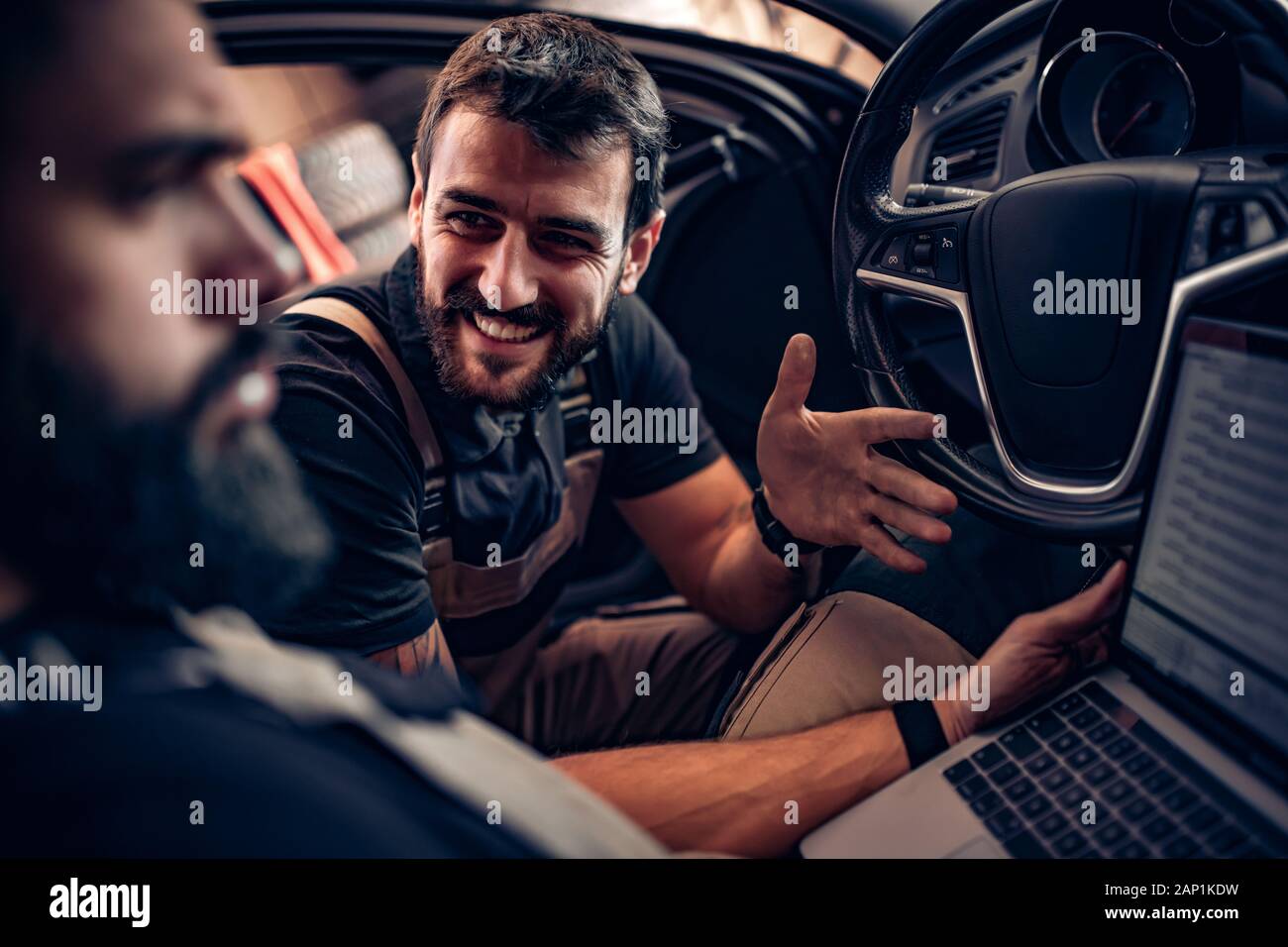 Professional car mechanics working in auto repair service Stock Photo