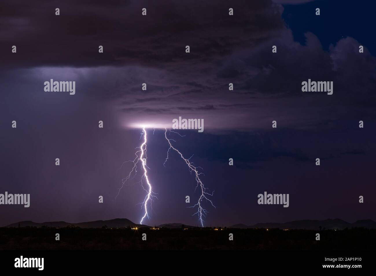 Vivid lightning bolts strike a mountain during a monsoon thunderstorm ...