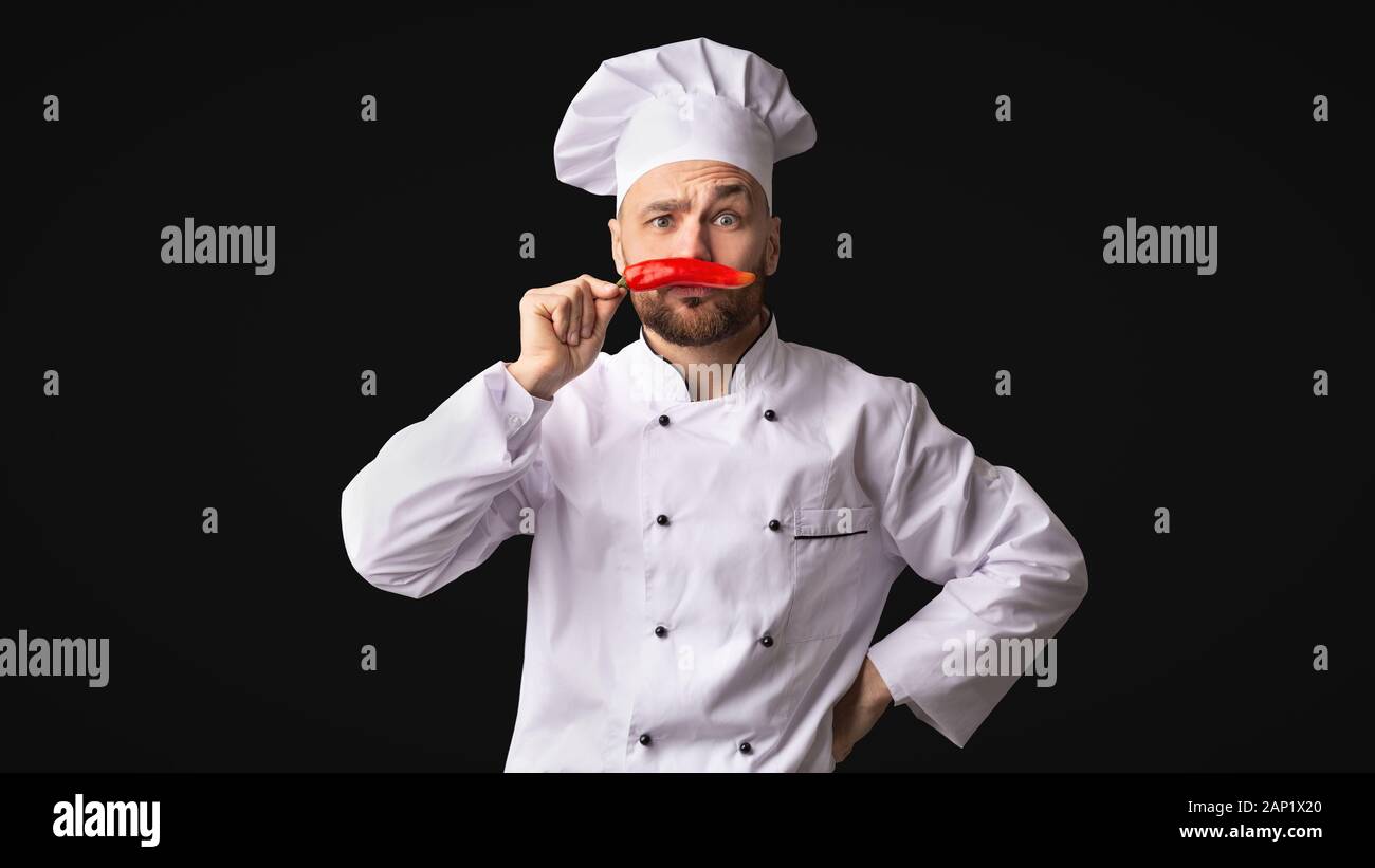 Funny Chef Holding Red Pepper Near Face Posing, Studio, Panorama Stock Photo