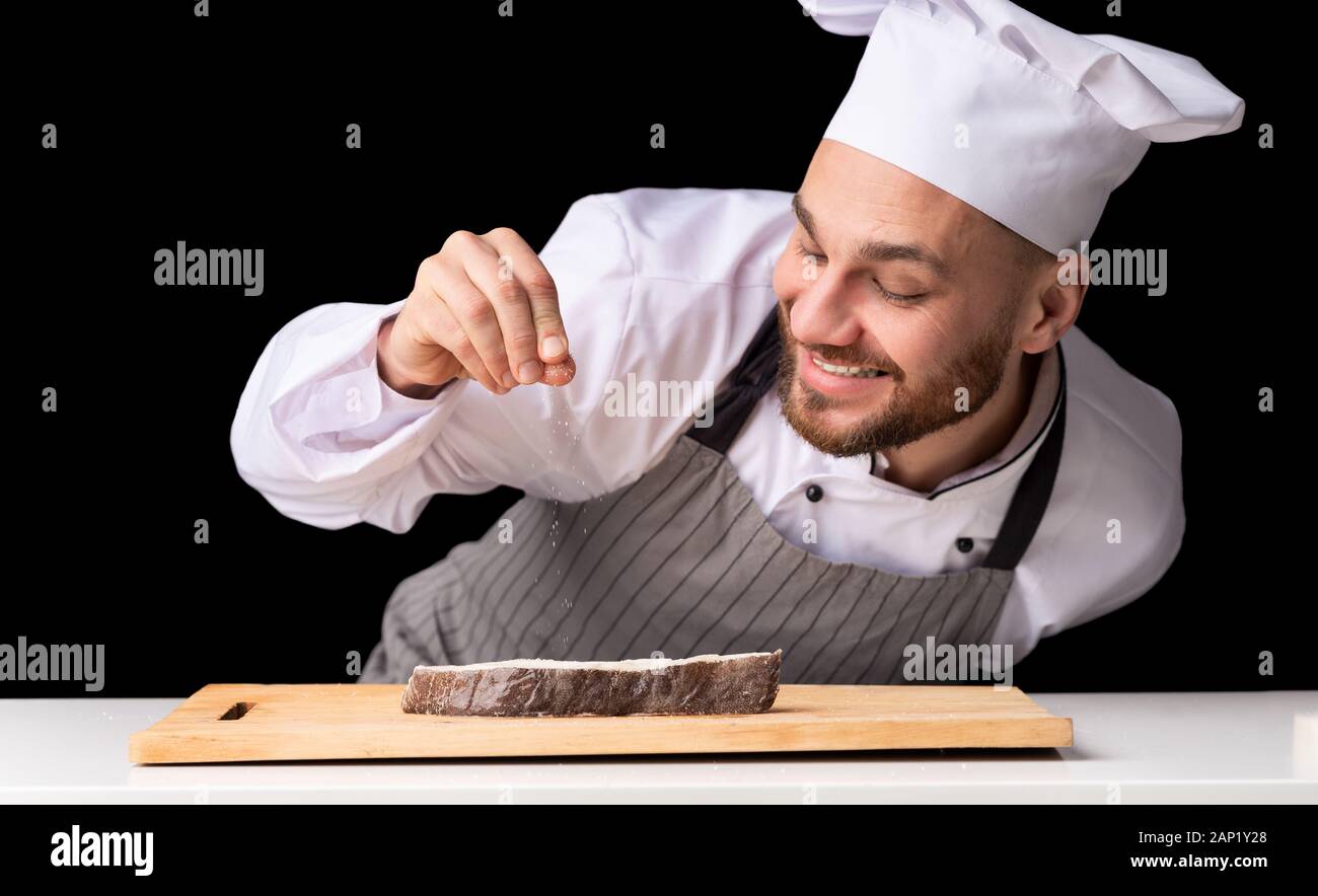 Chef Man Seasoning Salmon Steak Cooking Fish On Black Background Stock Photo