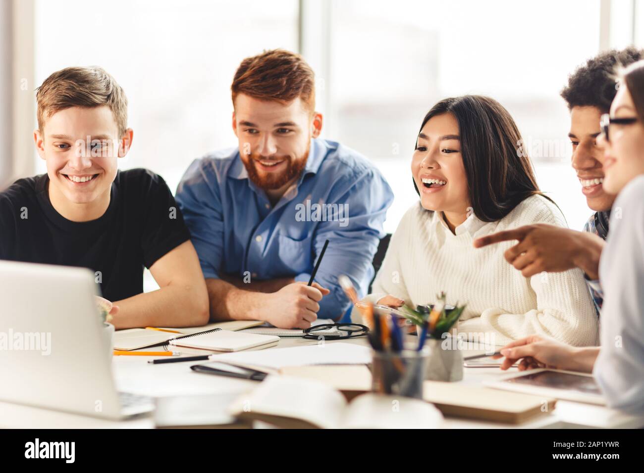 Team of college students talking over group project Stock Photo