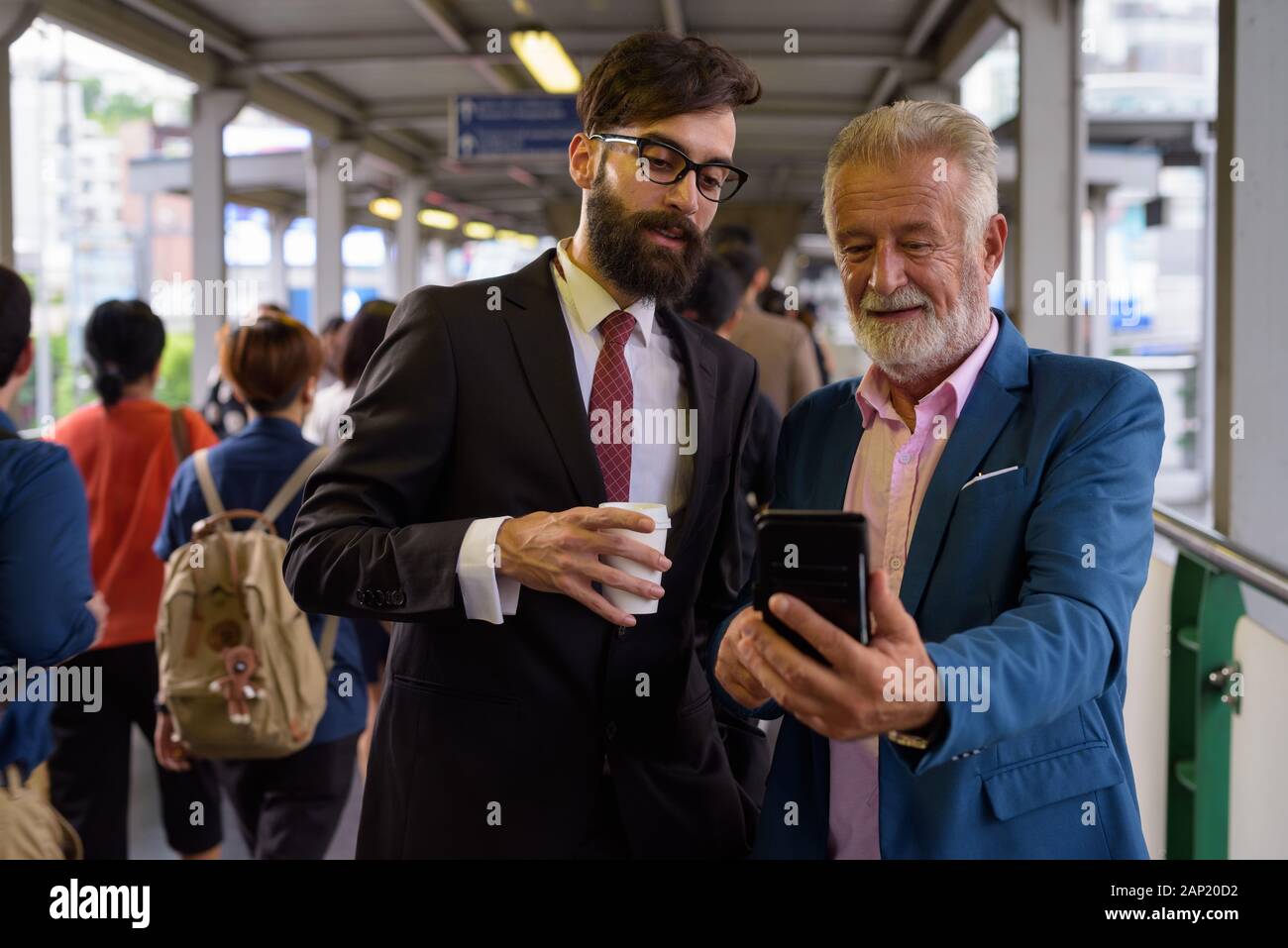 Two multi ethnic bearded businessmen together around the city Stock ...