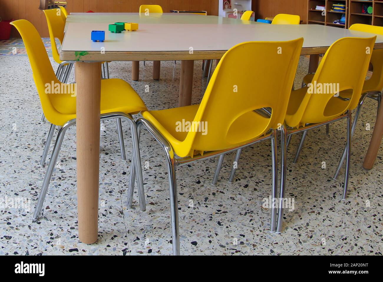 inside a classroom of a kindergarten with yellow chairs without the