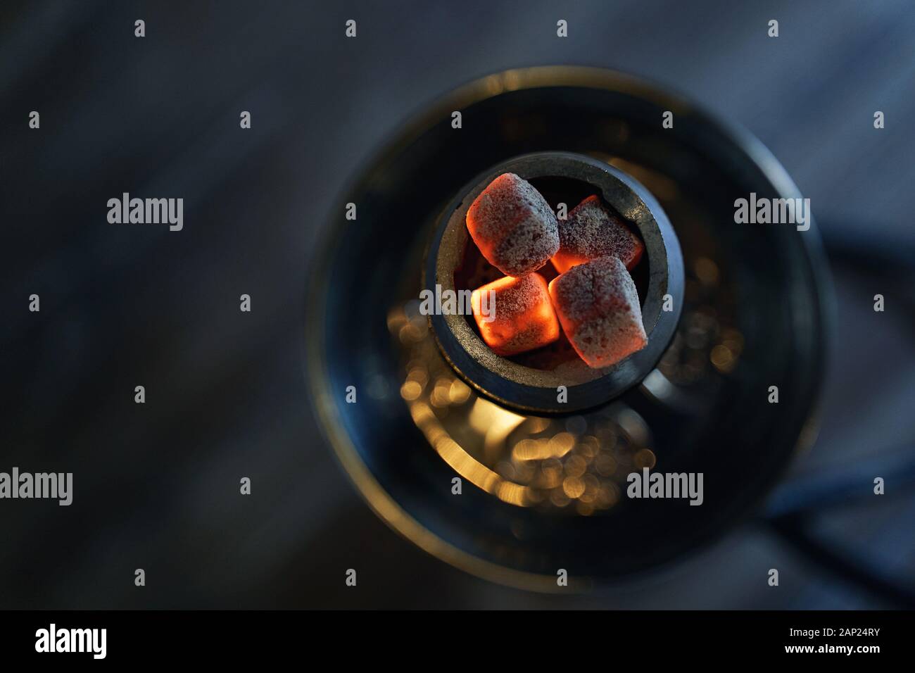 Shisha hookah bowl with red hot coals and craft tobacco. Modern hookah