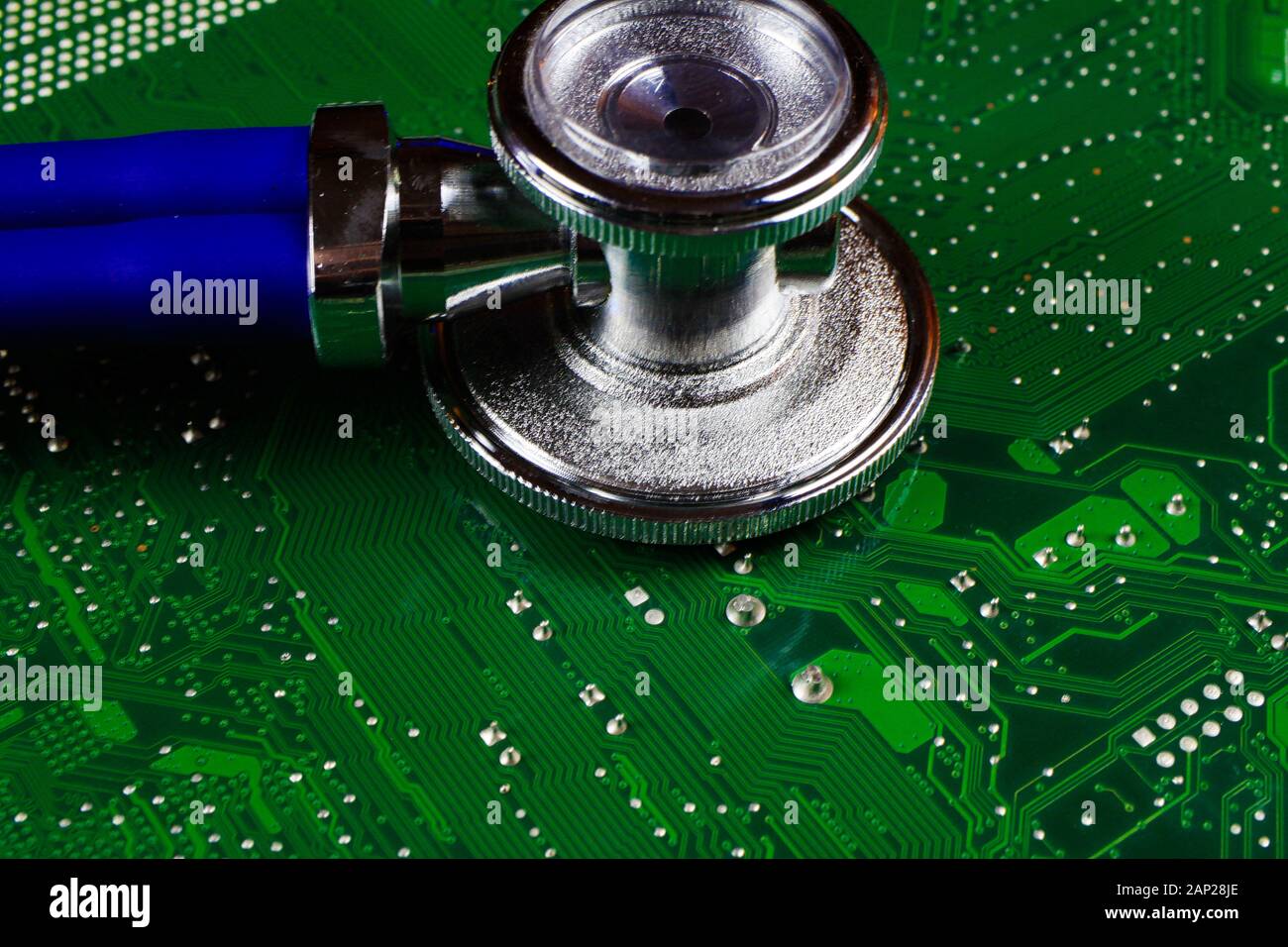 Digital health patient data storage concept Isolated blue stethoscope on green computer