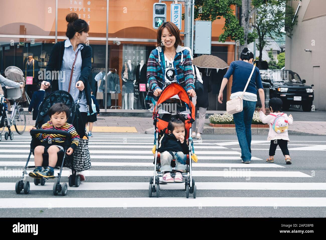 Crossing the street with a baby Stock Photo Alamy