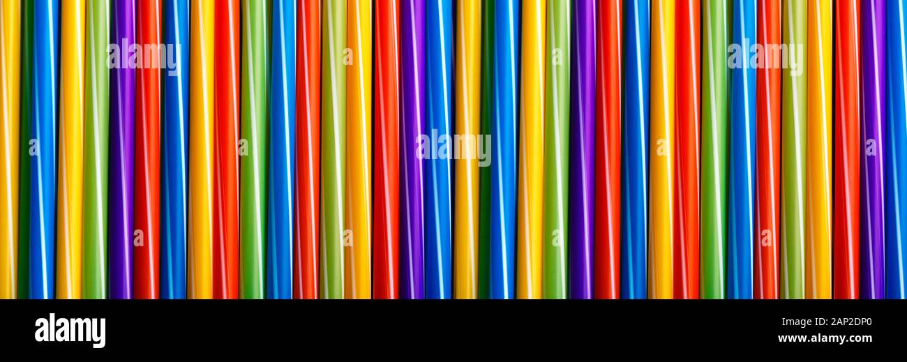 Many different colored plastic drinking straws vertically arranged, panoramic image Stock Photo