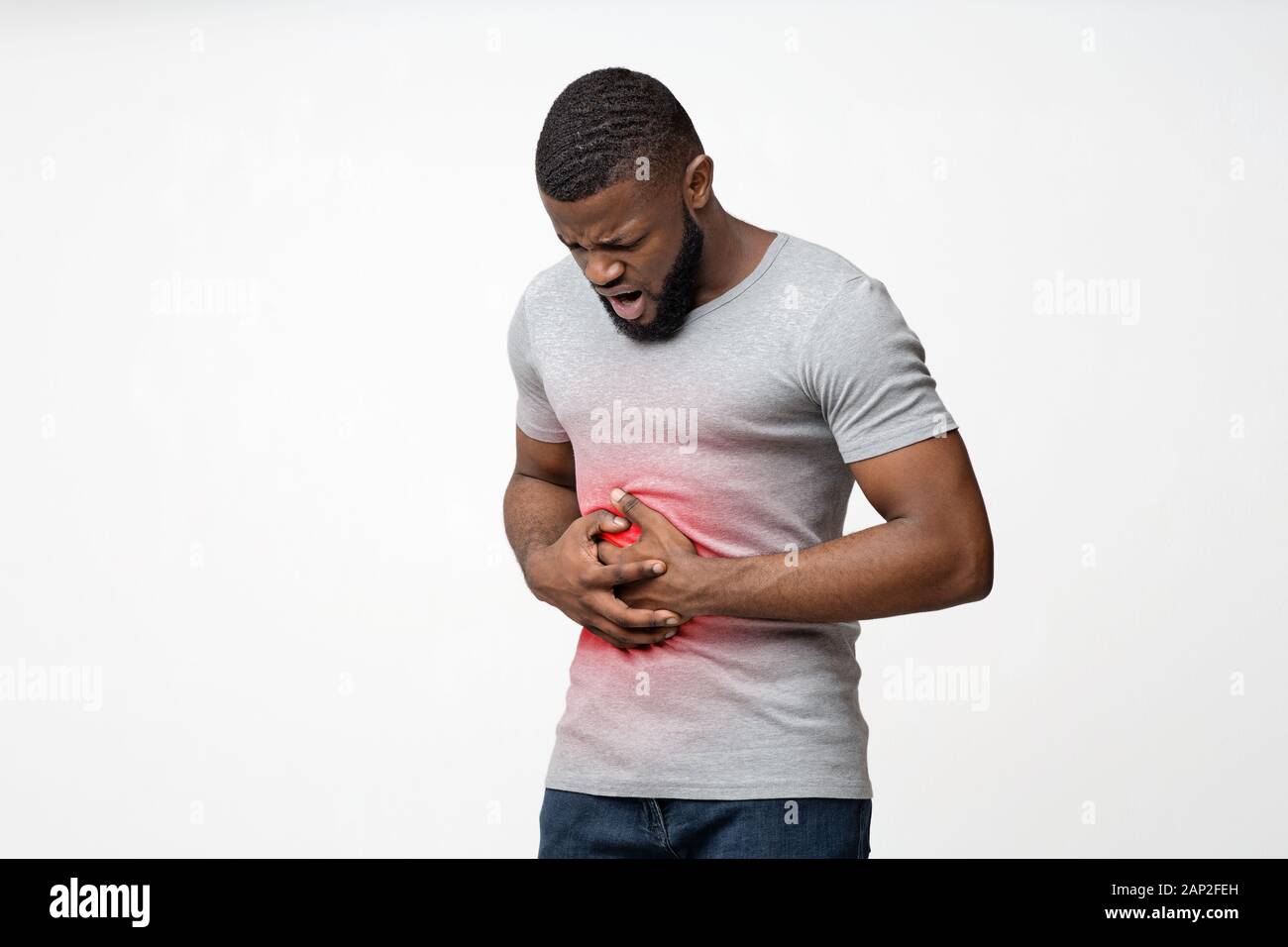 Young black guy suffering from stomach ulcer Stock Photo