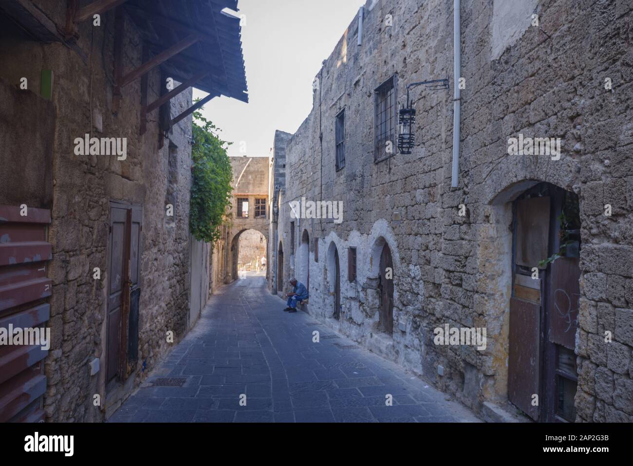 Narrow street in the medieval city inside of Fortifications of Rhodes. Stock Photo