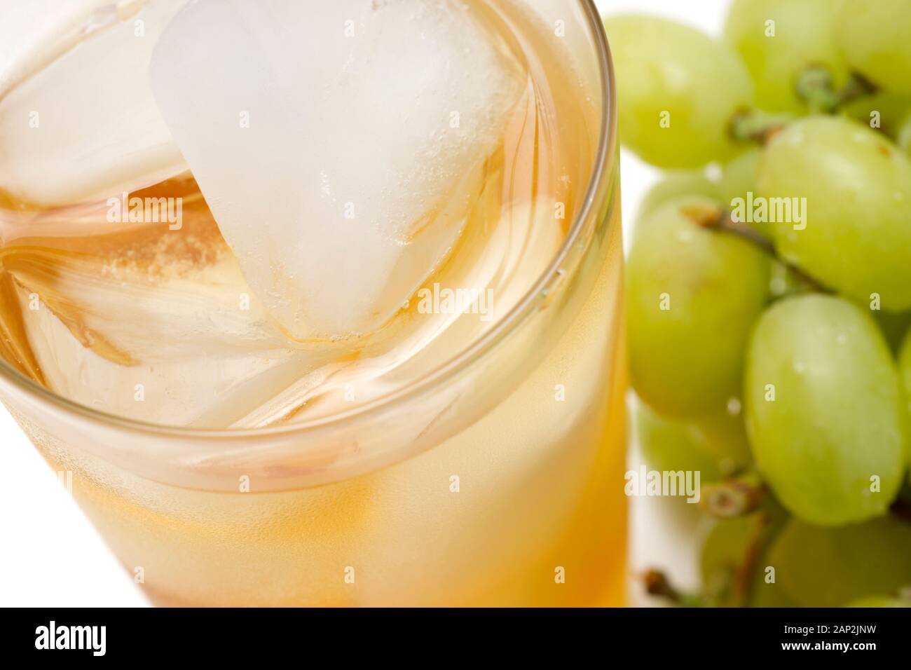 Glass of white grape juice with whole green grapes on background Stock ...
