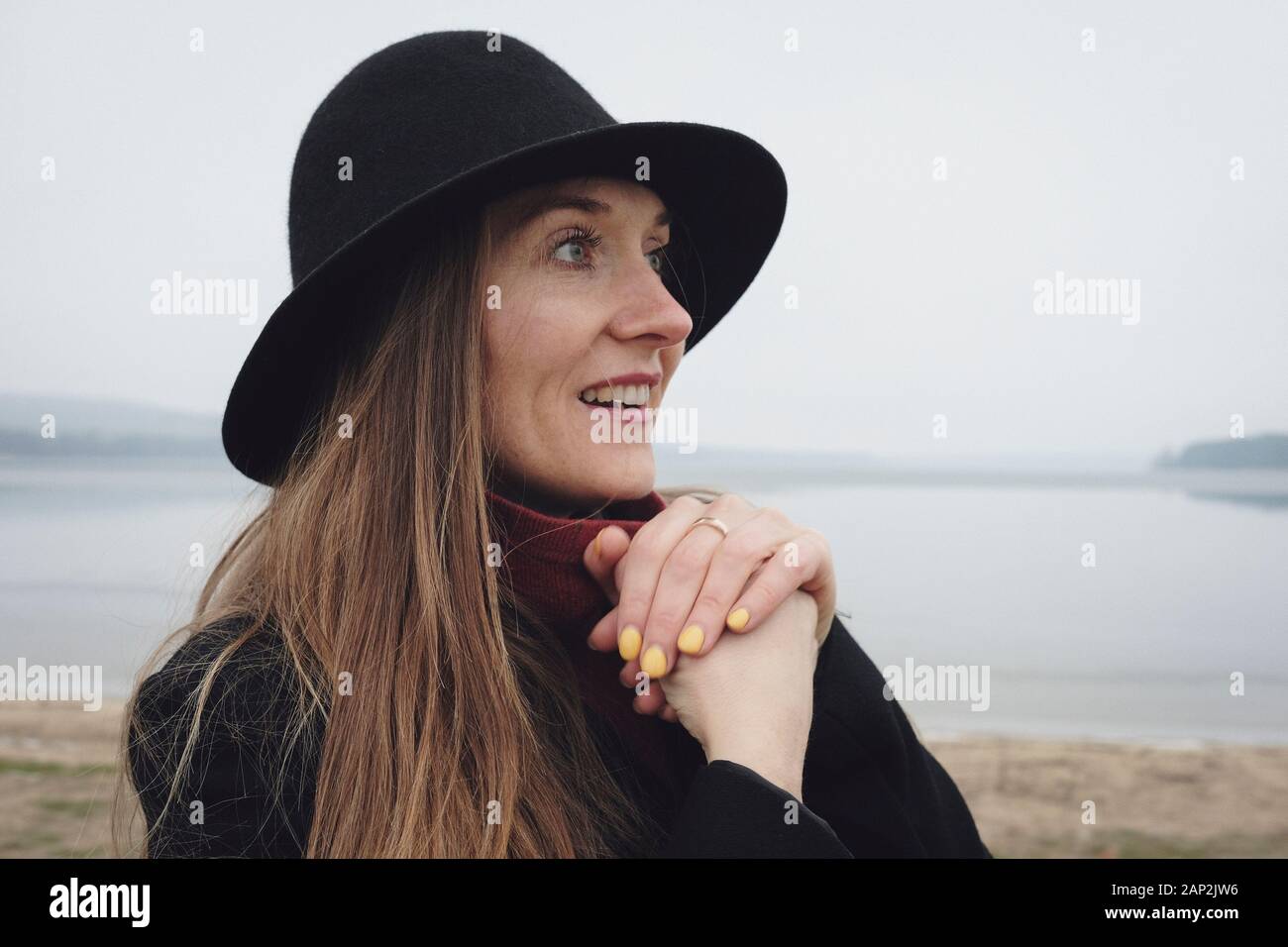 Side view portrait of a woman wearing a black hat Stock Photo