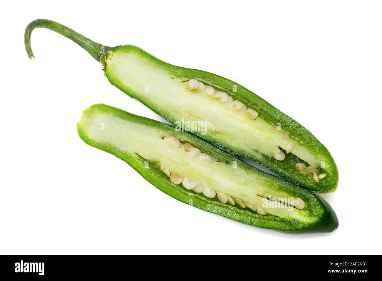 Five Serrano chili Peppers isolated on white background - one pepper cut in half. Stock Photo