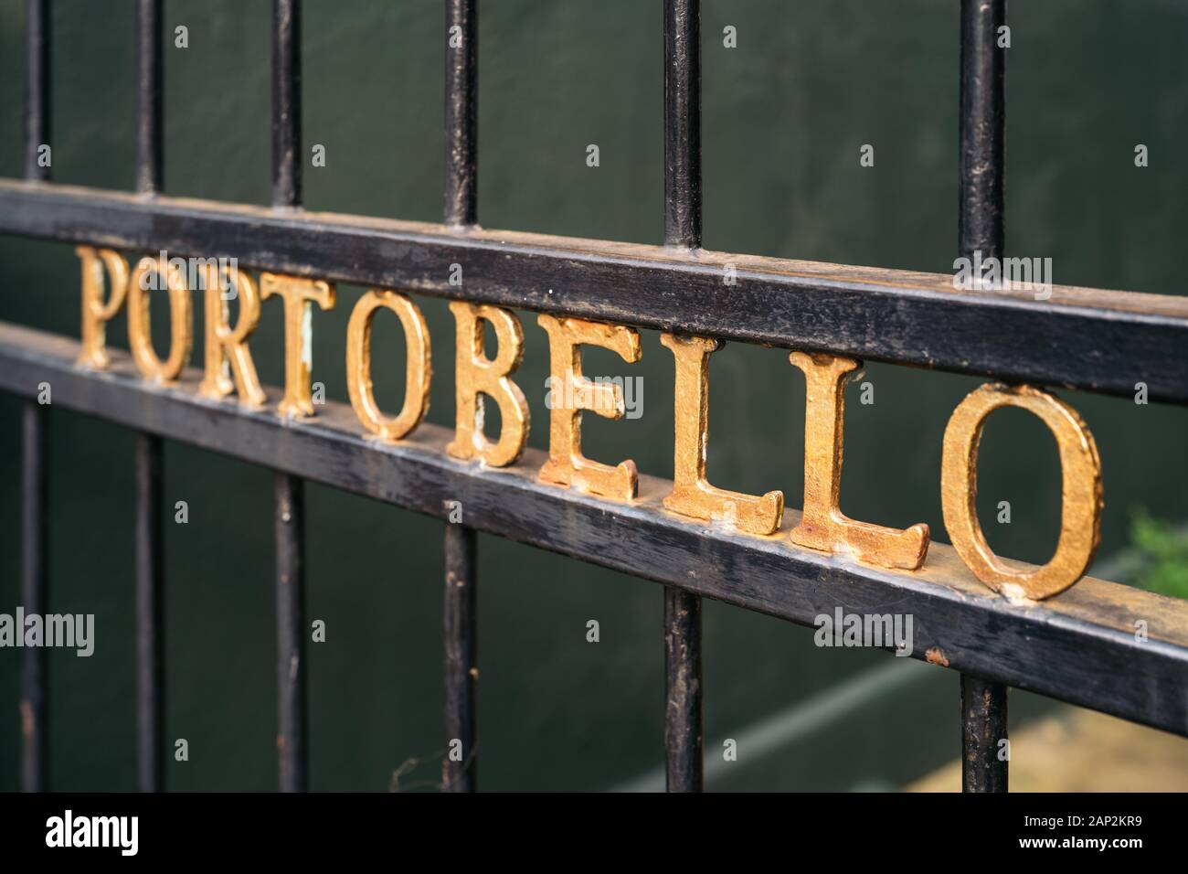 Mews entrance gate on Portobello Road. Grid Entrance door with gold