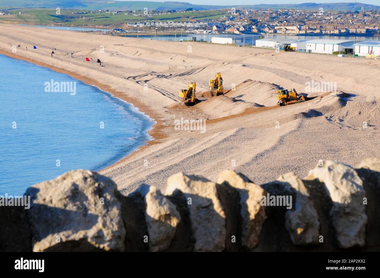 Environment Agency workers remodel Chesil Beach after recent storms, on
