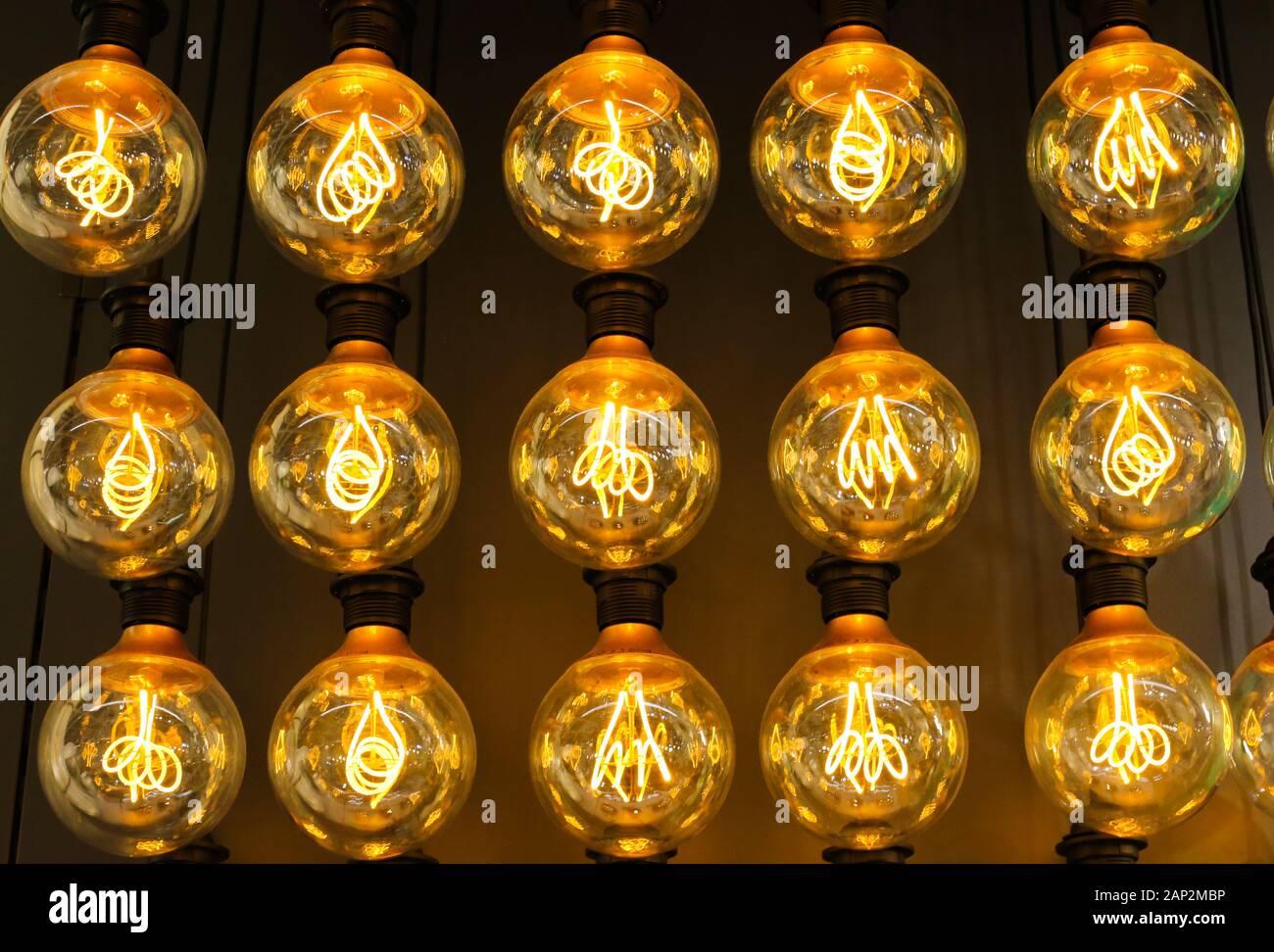 Isolated group of yellow gold shining retro classical light bulbs in