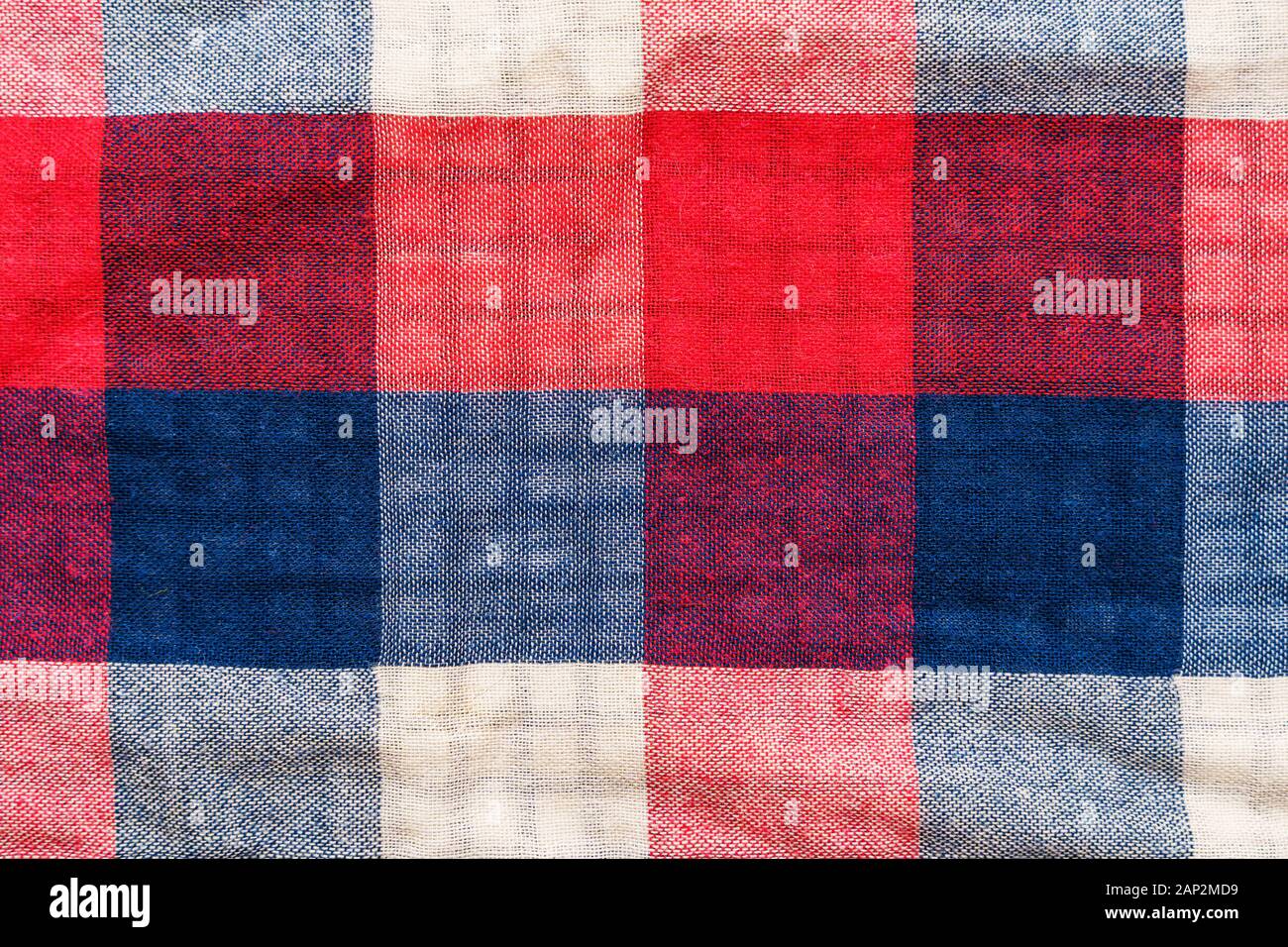 Plaid material texture. Red, blue and white cage clothes background Stock Photo