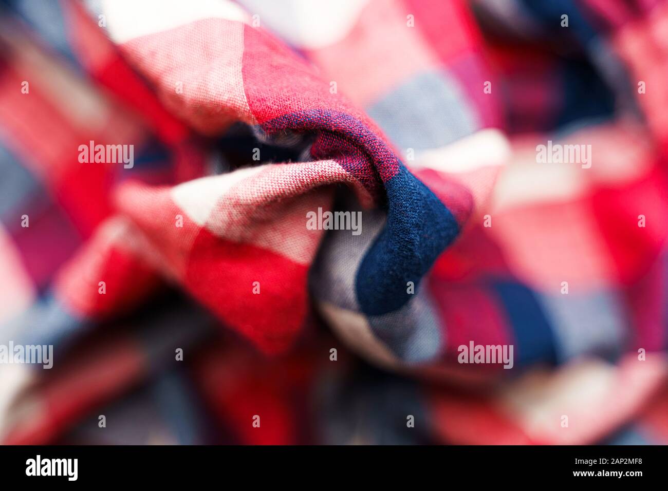 Plaid material texture. Red, blue and white cage clothes background Stock Photo