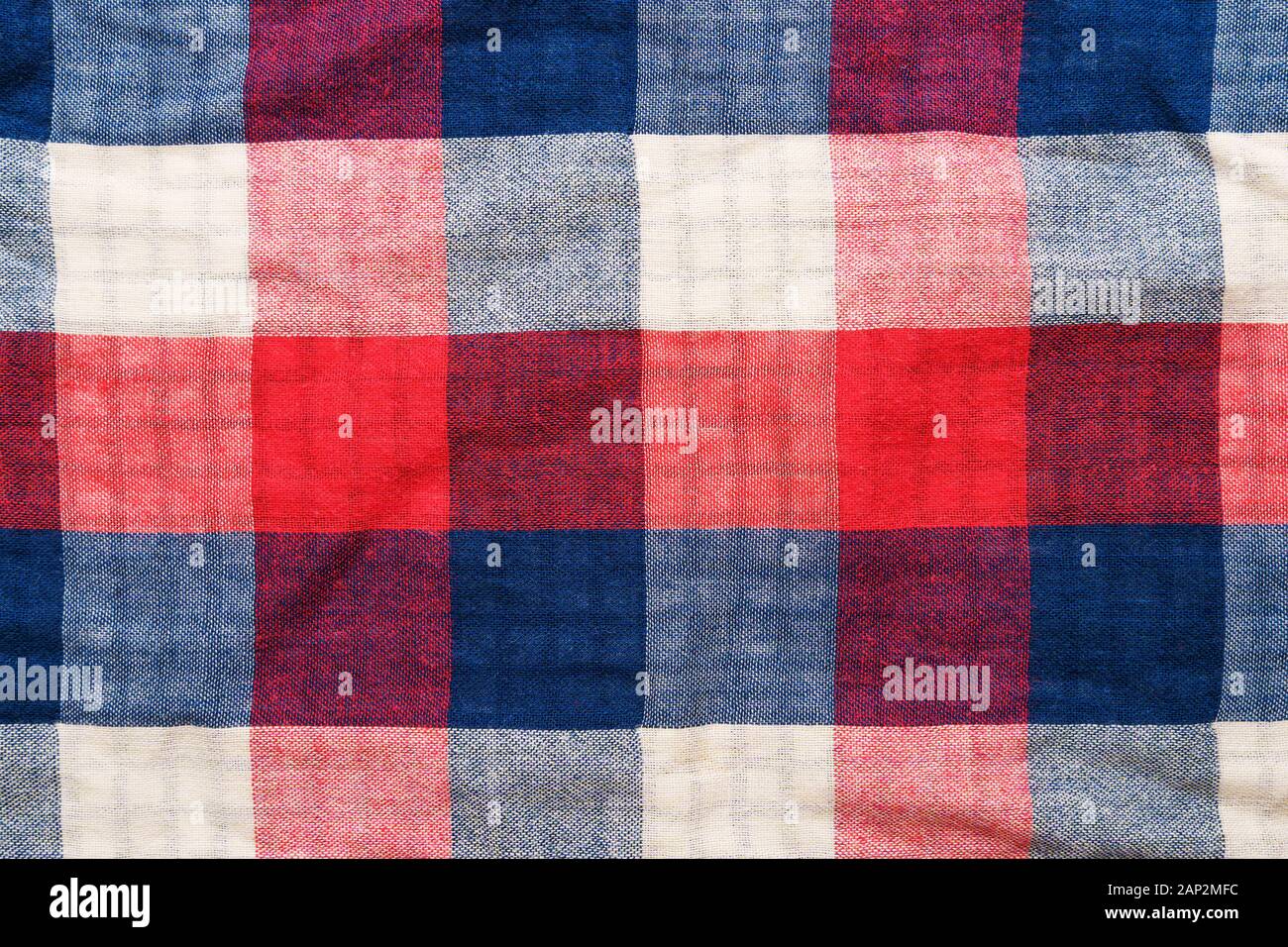 Plaid material texture. Red, blue and white cage clothes background Stock Photo