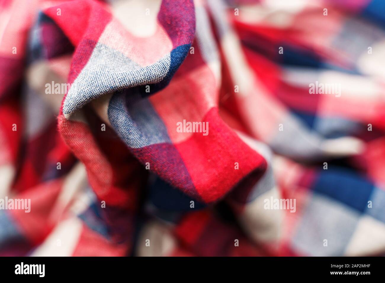 Plaid material texture. Red, blue and white cage clothes background Stock Photo