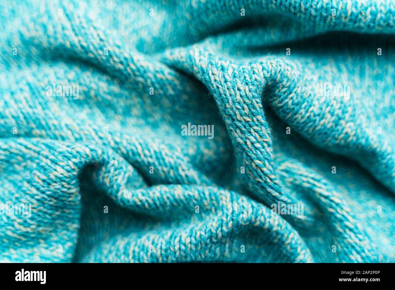 Crumpled texture of a blue turquoise knitted fabric. Sweater background ...