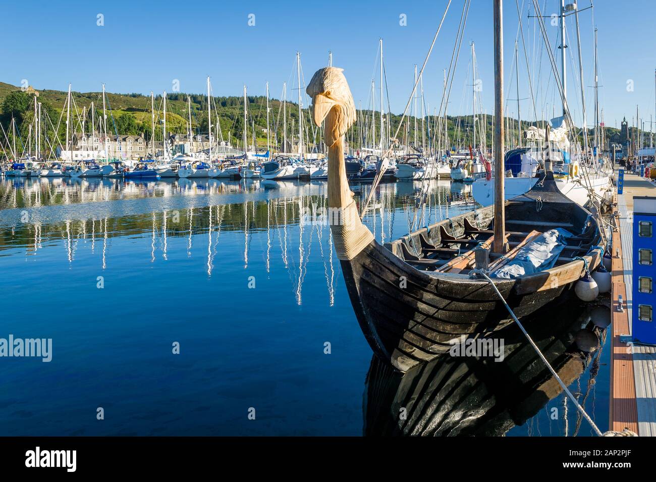 Old drakkar - historic viking's boat at Tarbert marina. Hebrides, Scotland. Stock Photo