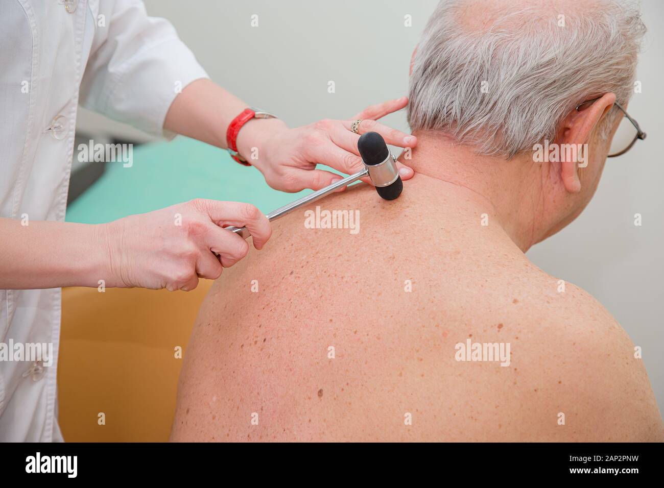 Orthopedic surgeon examining the knee reflex. The doctor checks the physiological reflex, the