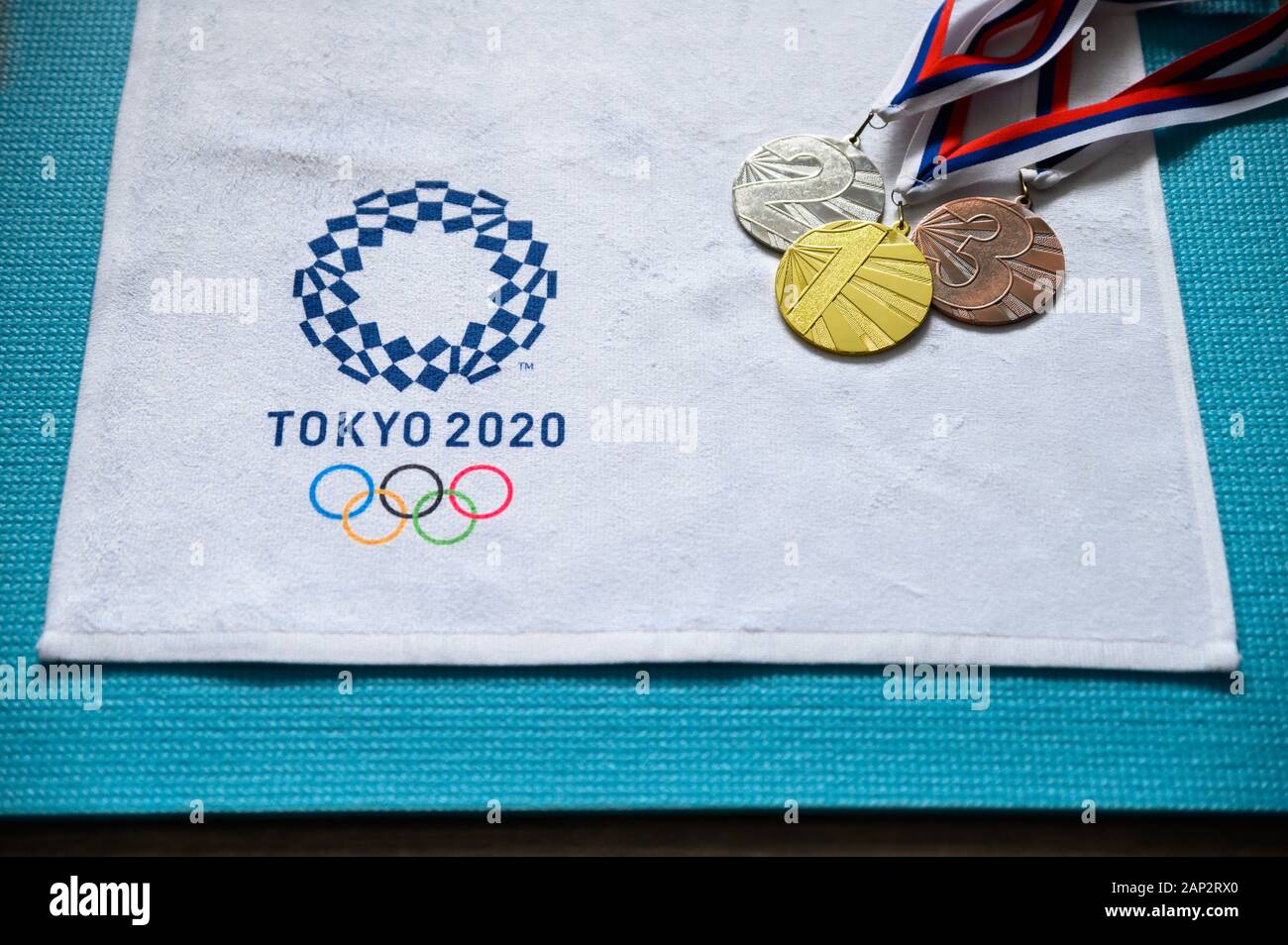 TOKYO, JAPAN, JANUARY. 20. 2020: Gold silver and bronze medal, tokyo 2020 summer olympic game logo, white background Stock Photo