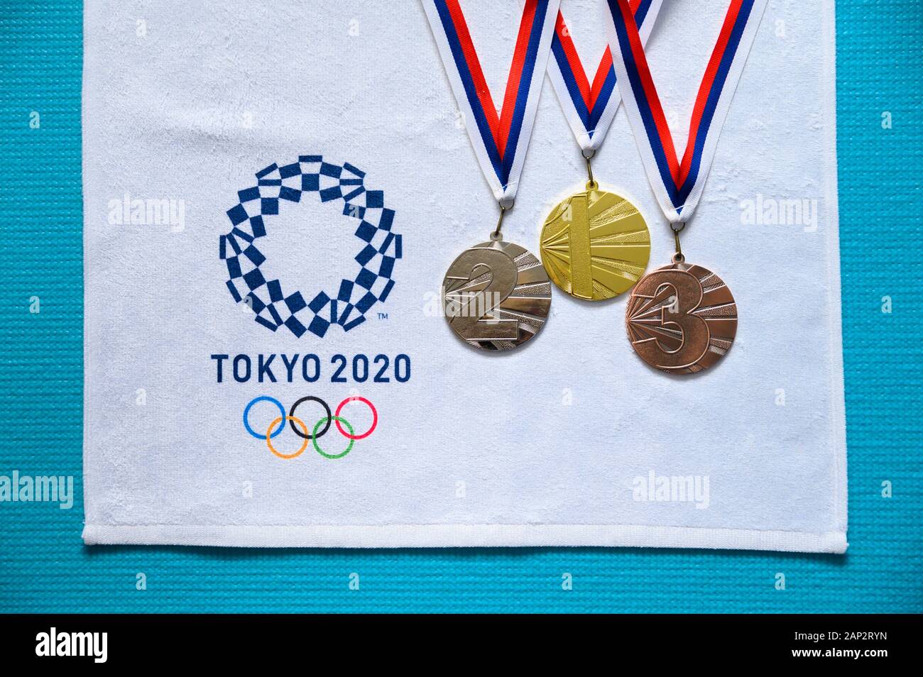 TOKYO, JAPAN, JANUARY. 20. 2020: Summer olympic medal ceremony. Gold silver and bronze set. Tokyo 2020 summer game logo Stock Photo