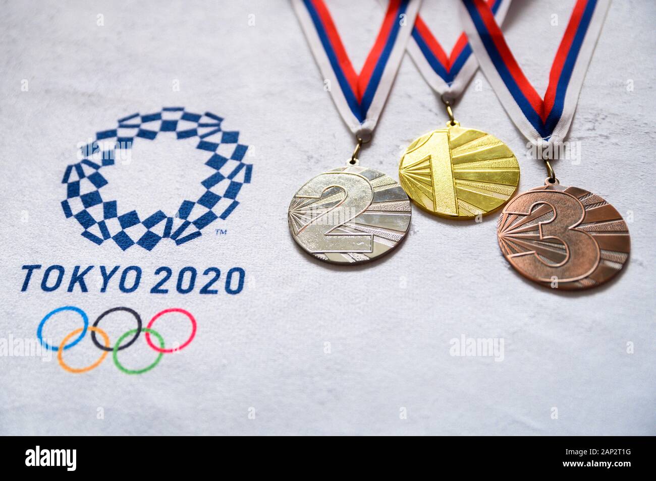 TOKYO, JAPAN, JANUARY. 20. 2020: Gold silver and bronze medal set, olympic logo Tokyo 2020 on white background Stock Photo